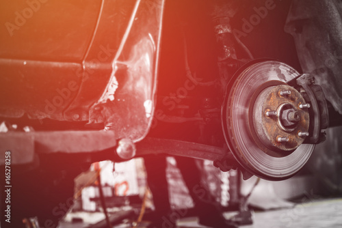 Car lifted in automobile service for fixing, repair, changing brake pads in garage