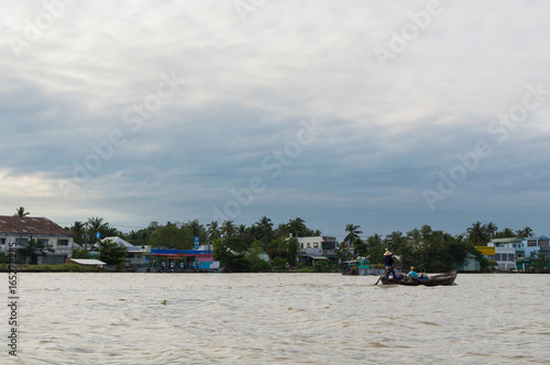Canvas-taulu Riverside stilt houses in the Mekong Delta