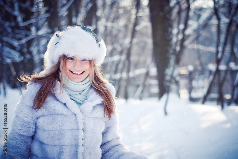 Beautiful girl in a winter snowy park Beautiful girl in a winter snowy park