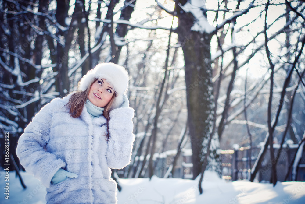 Beautiful girl in a winter snowy park Beautiful girl in a winter snowy park