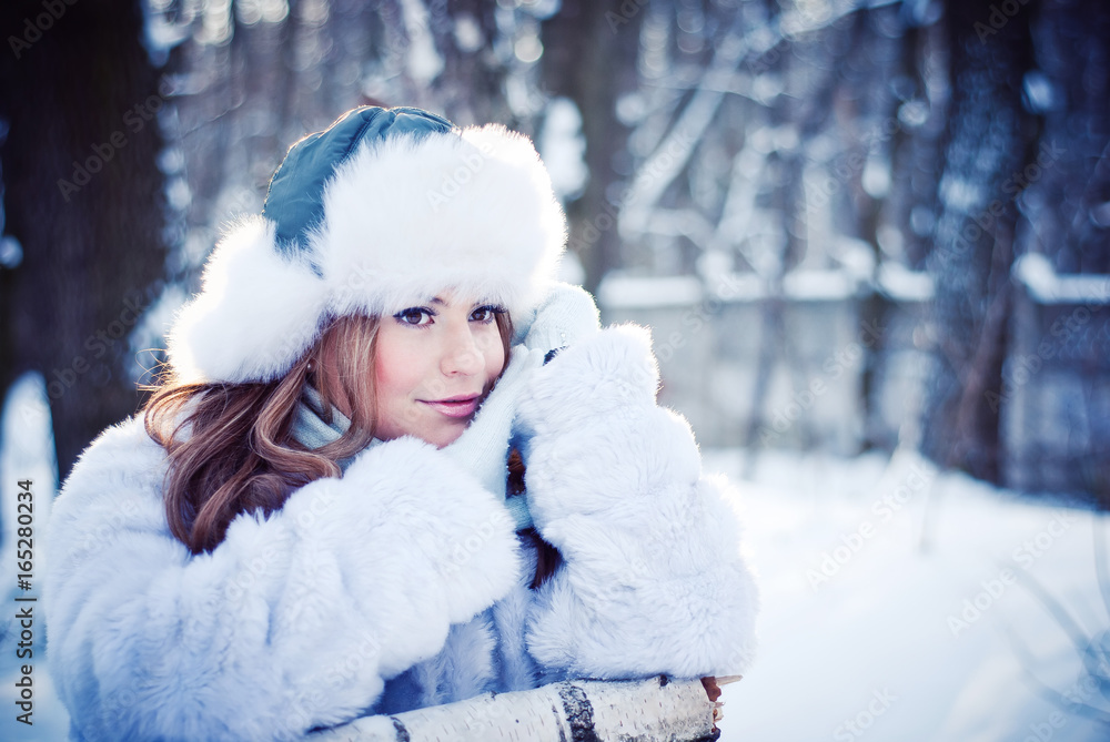 Beautiful girl in a winter snowy park Beautiful girl in a winter snowy park