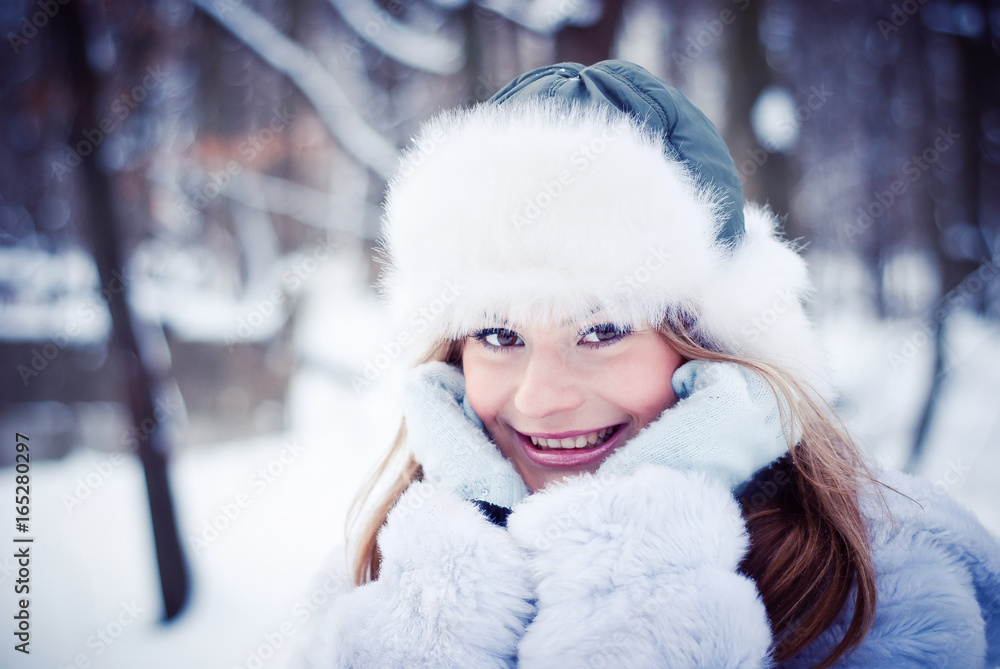 Beautiful girl in a winter snowy park Beautiful girl in a winter snowy park