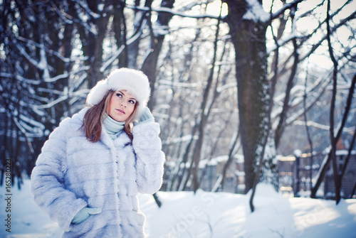 Beautiful girl in a winter snowy park