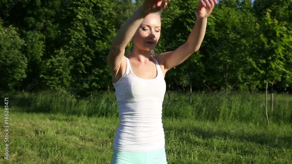 Beautiful blonde woman engaged in fitness in the park Beautiful blonde woman engaged in fitness in the park