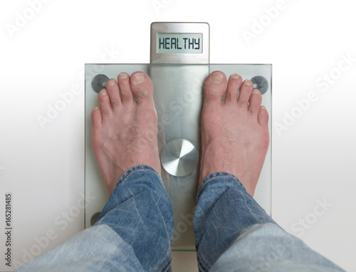 Man's feet on weight scale - Healthy