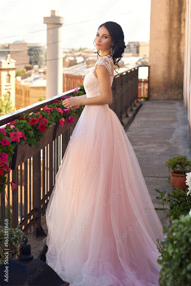Premium Photo | Beautiful blonde women in pink evening gown smiling.  perfect hairstyle, makeup and summer flowers