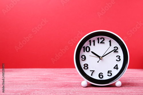 Wallpaper Mural Black clock on red wooden table Torontodigital.ca