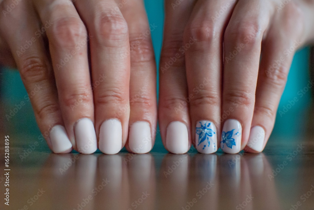 Beautiful manicure made on the nails on the fingers with colored varnish Beautiful manicure made on the nails on the fingers with colored varnish