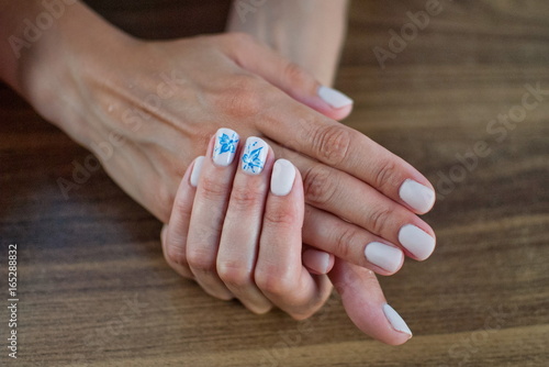 Beautiful manicure made on the nails on the fingers with colored varnish