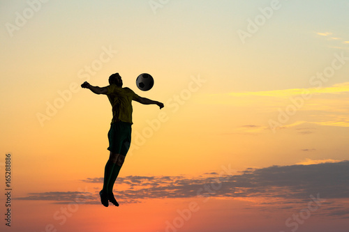 Fototapeta Naklejka Na Ścianę i Meble -  Soccer player with ball outdoors