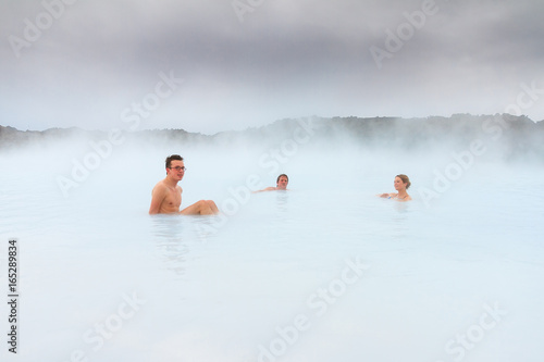Fotografie Sick people healing in the blue mineral waters of a geothermal spa in Iceland