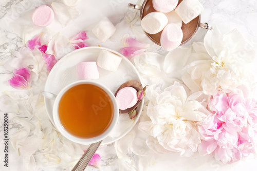 Beautiful still life with tea cup and peonies.Top view