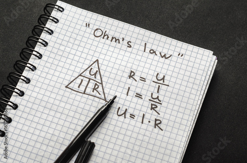 Page with formulas and Ohm's law with pen