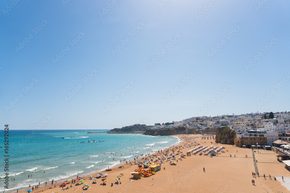 Portugal algarve old town albufeira and sandy city beaches people sunbathe and rest near the sea. Summer time