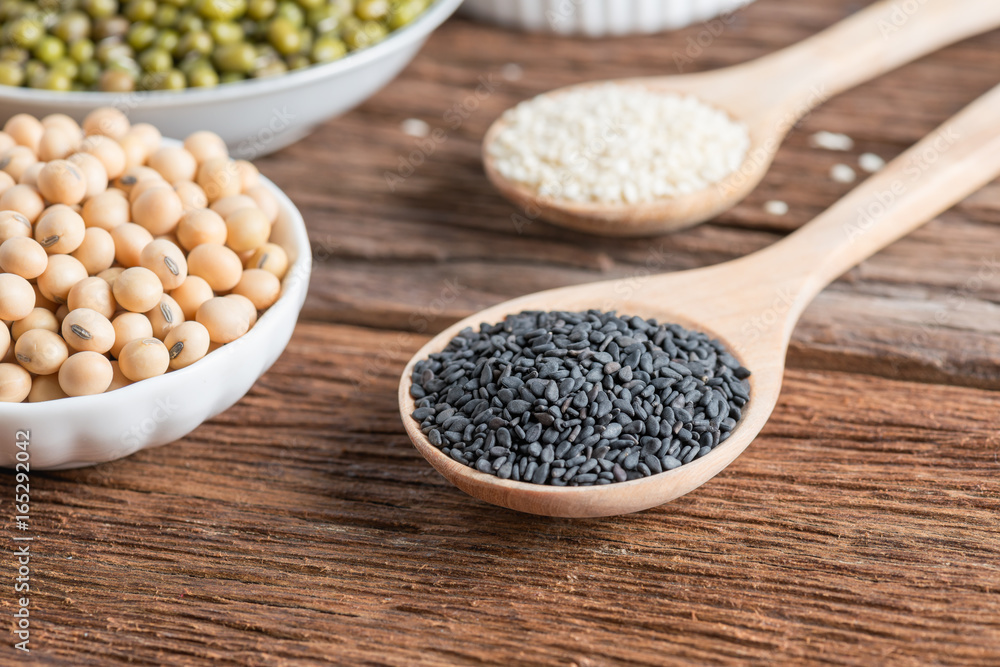 Black sesame and White sesame, nut on wood background. Black sesame and White sesame, nut on wood background.