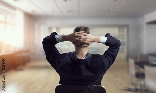 Businessman in chair having rest