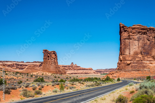 Road in the desert Moab. Scenic Arches National Park. Sandstone Cliffs