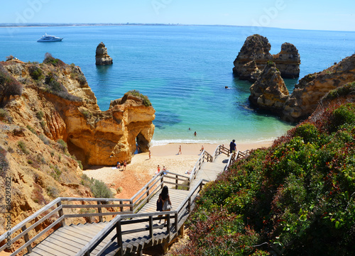 Wooden Stairs to Praia do Camilo at Algarve with blue Atlantic at Horizon