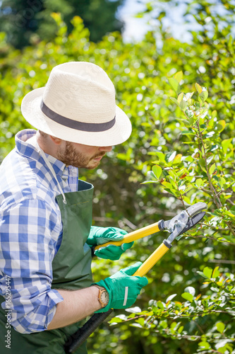 young gardener with a professional tools and equipment