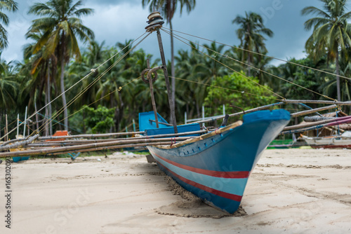 A traditional banca fishingboat facing the ocean on the beach