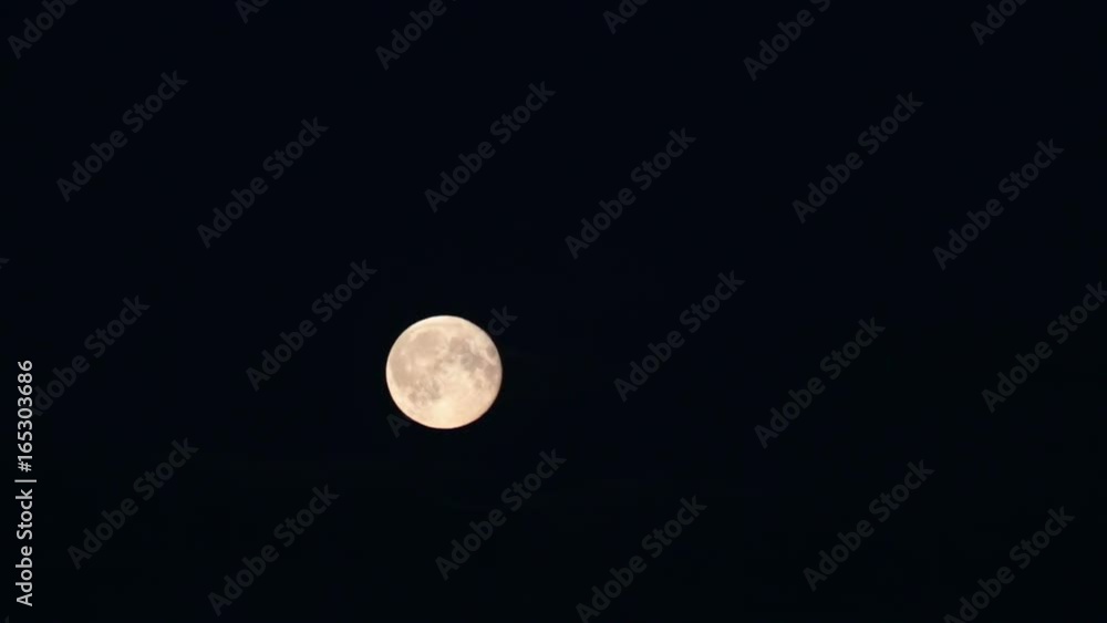 The full moon moves on the sky through clouds The full moon moves on the sky through clouds