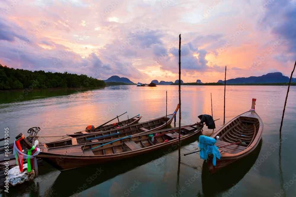longtail boat with coastal fishing village ,Beautiful morning sunrise over sea and mountain in phang - nga thailand