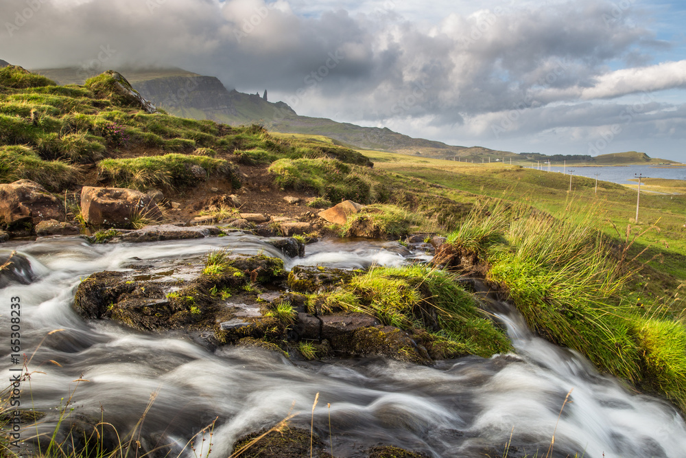 Bride's veil waterfall with Old man of Storr in the background. Isle of Skye, Scotland. Bride's veil waterfall with Old man of Storr in the background. Isle of Skye, Scotland.