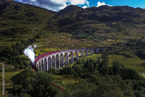 Train on famous Glenfinnan viaduct, Scotland, United Kingdom photo