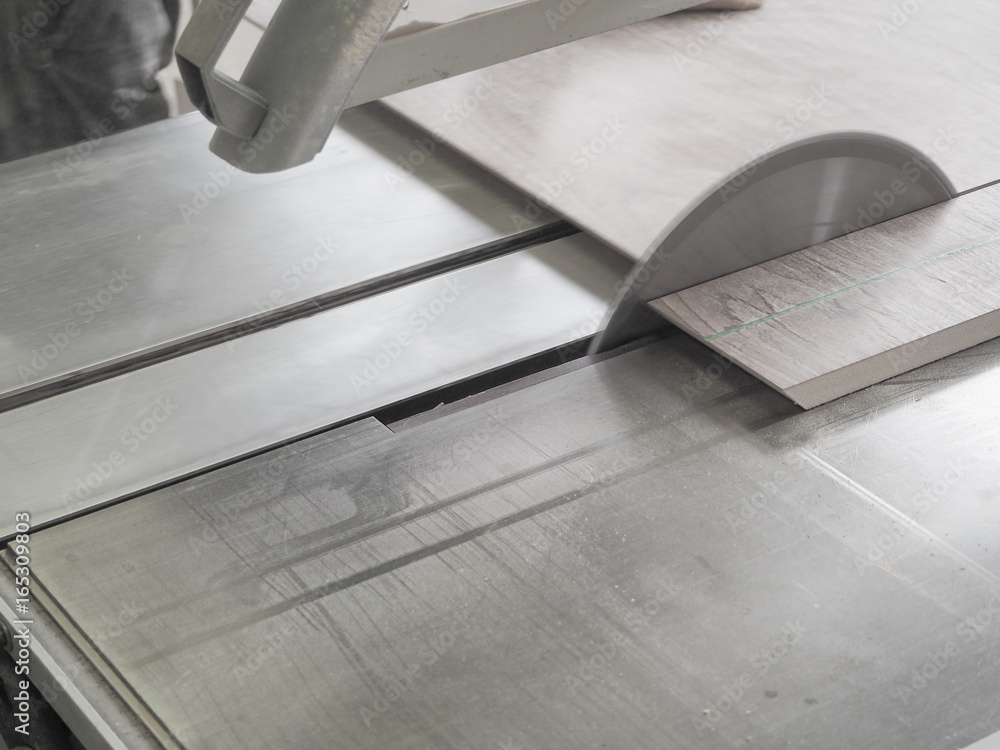 Cut the parts from chipboard on a circular saw at a furniture factory