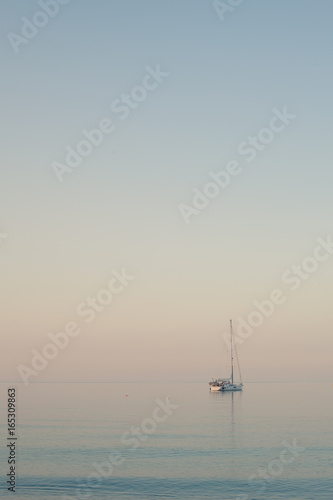 Sailing boat in the sea at the twilight