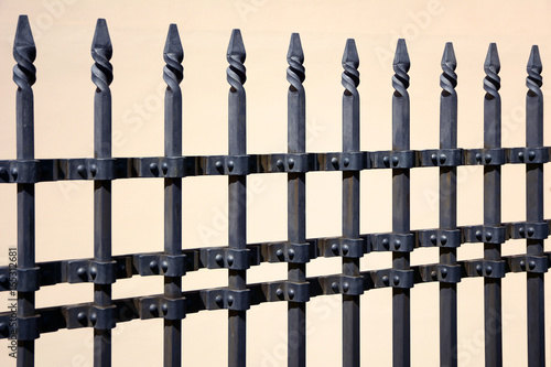 Beautiful wrought fence. Image of a decorative cast iron fence. metal fence close up. Metal Forged Fence. Beautiful fences with artistic forging