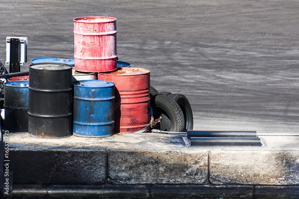 barrels on the dock along with some tires barrels on the dock along with some tires