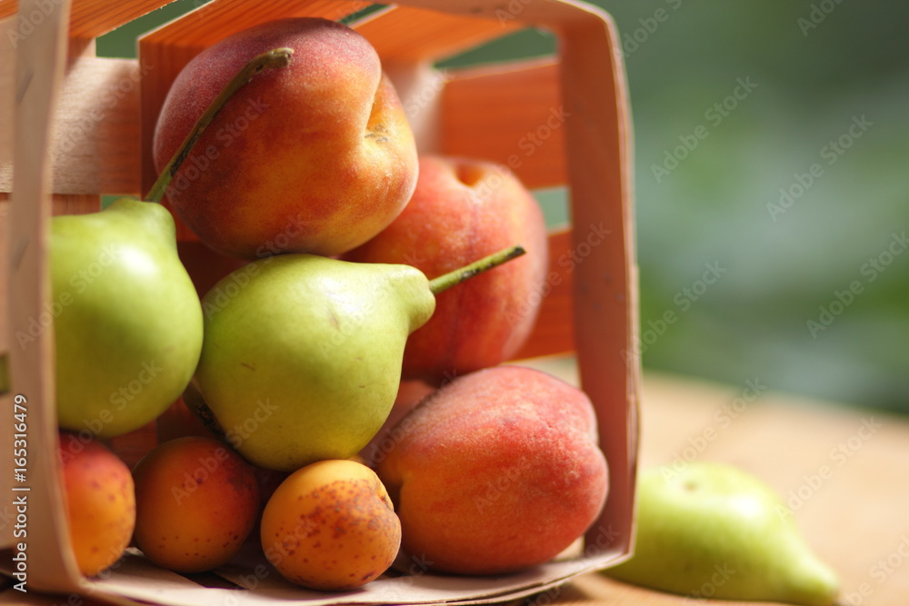 Pears and peaches in a wooden basket Pears and peaches in a wooden basket