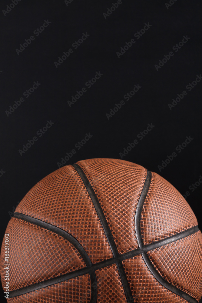Old basketball ball on black background copy space Old basketball ball on black background copy space