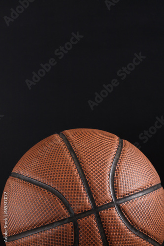 Old basketball ball on black background copy space © Prostock-studio