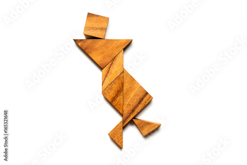 Wood tangram puzzle in dancing man shape on white background  Concept for happiness  joy 