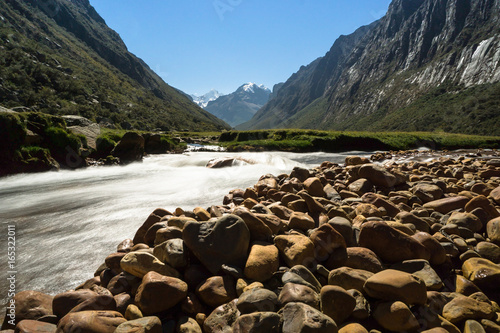 mountain river and red rock river bank in beautiful mountain valley in the Andes in the Cordillera Blanca in Peru