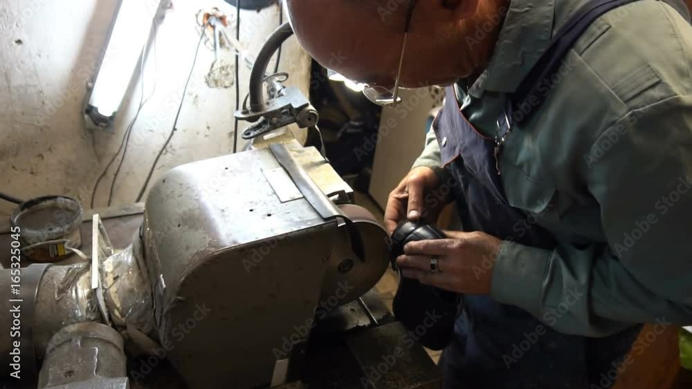 shoemaker hones taps on the machine. shoemaker hones taps on the machine.