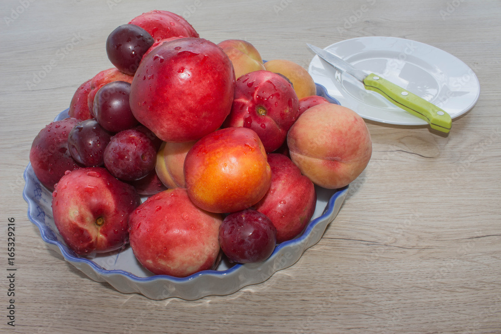 Nectarine, peaches and plums with water drops on wood table. fruit on the table Nectarine, peaches and plums with water drops on wood table. fruit on the table
