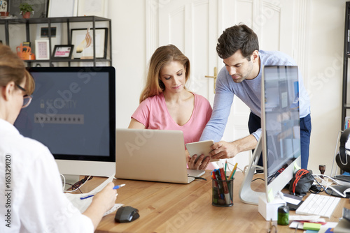 Teamwork in the designer studio. Shot of a beautiful young businesswoman and a handsome businessman working together on computer. 