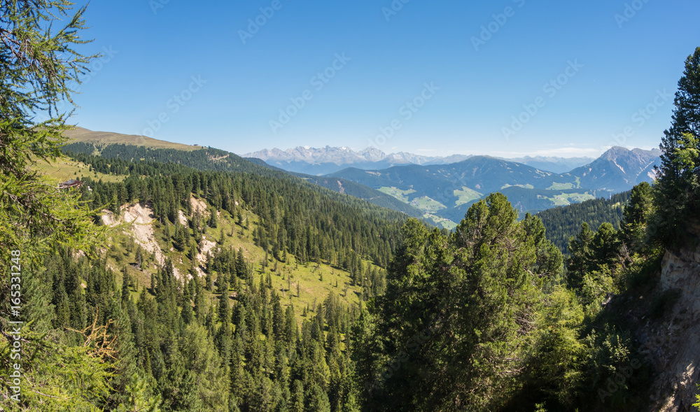 Drone aerial views of the mountains and the meadows of the Dolomites. The place is around the Pass of Herbs