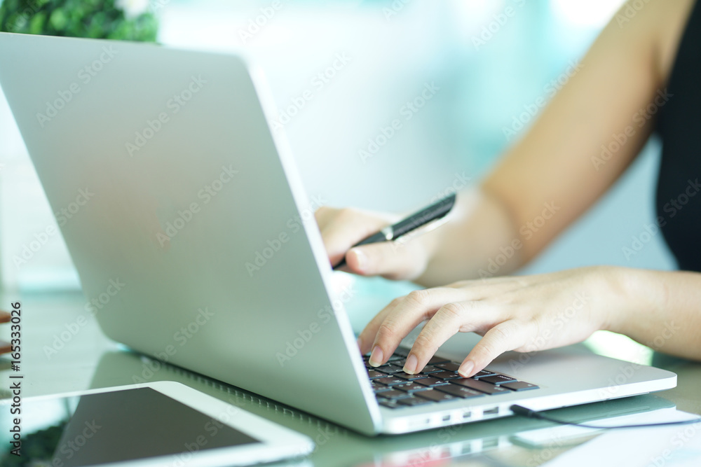 Fototapeta premium close up work secretary woman working by typing on laptop computer in office room.