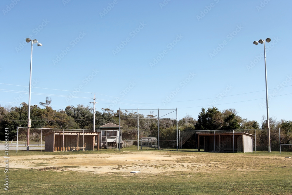 Small town USA baseball park. Worn infield and blue sky. Small town USA baseball park. Worn infield and blue sky.
