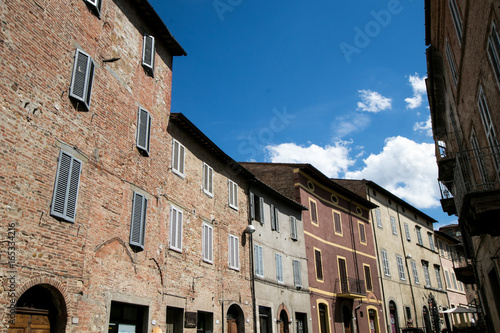 Sunny facades of elegant palaces in a medieval village in Italy