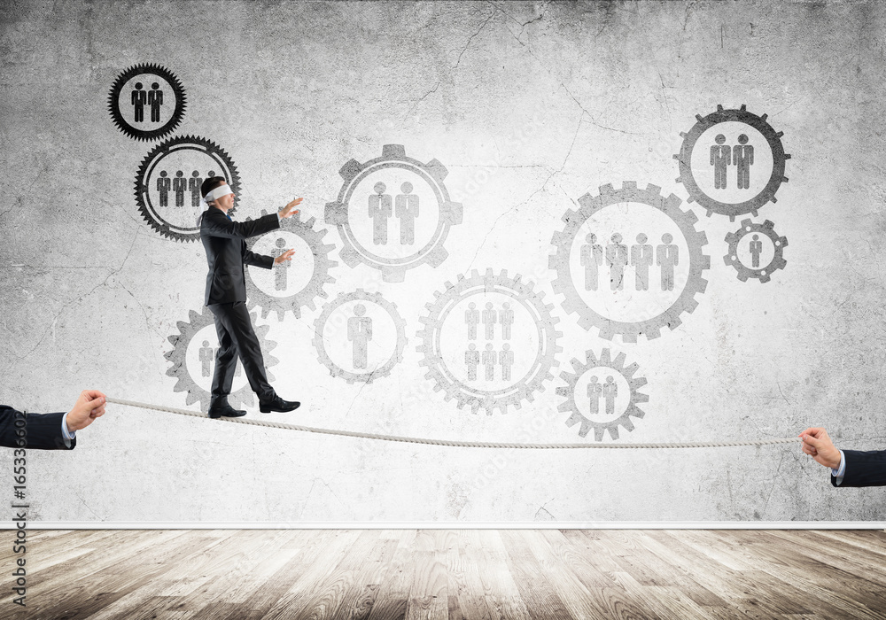 Business concept of risk support and assistance with man balancing on rope Business concept of risk support and assistance with man balancing on rope