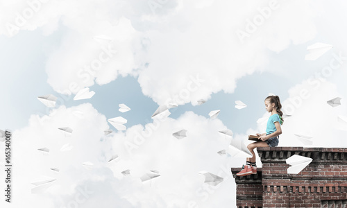 Concept of careless happy childhood with girl and paper plane fl