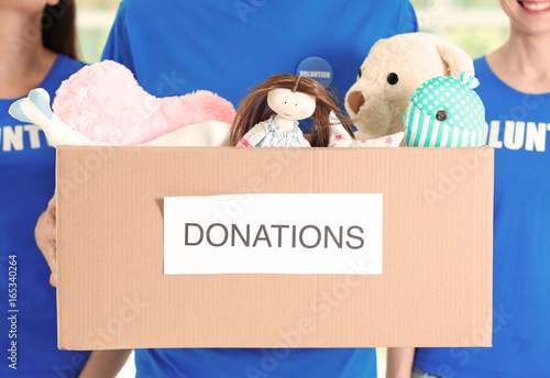 Young volunteers with box o...