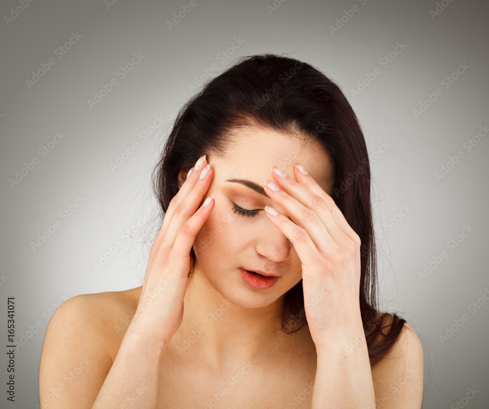Woman massaging pain head Woman massaging pain head