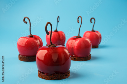 Glossy mousse cakes in the form of cherries photo