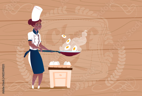 Female African American Chef Cook Frying Eggs Cartoon Chief In Restaurant Uniform Over Wooden Textured Background Flat Vector Illustration